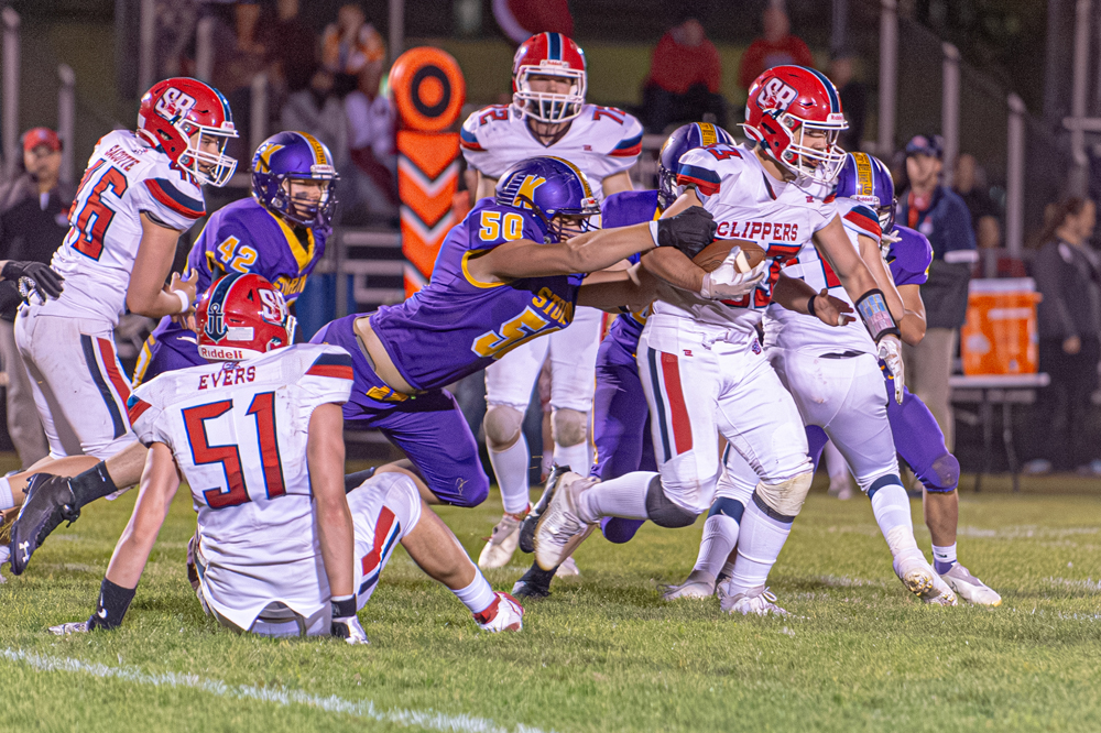 Kewaunee lineman Matthew Boeder locks on to Sturgeon Bay’s Craven Lautenbach late in the Storm’s  week seven blowout win against the Clippers.