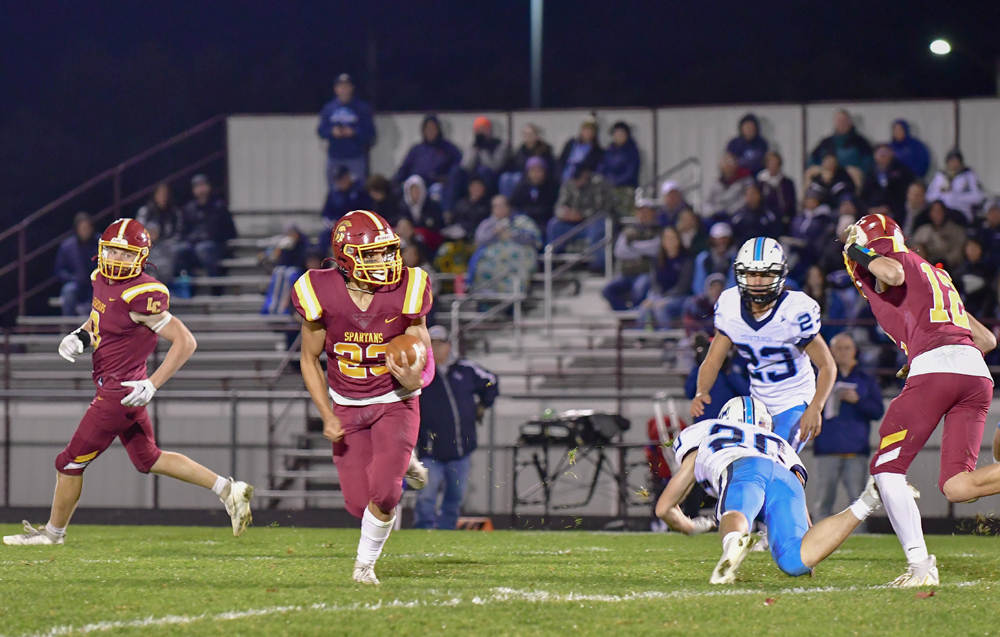 After taking the handoff from quarterback Max Ronsman,, L-C running back Cam Dorner heads upfield for a big gain on Friday against Little Chute. Ron LeCloux photo