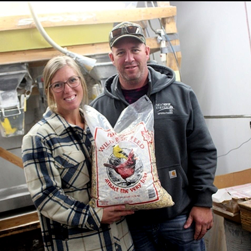 Jimmie and Chrissy Sullivan with a large bag of bird seed