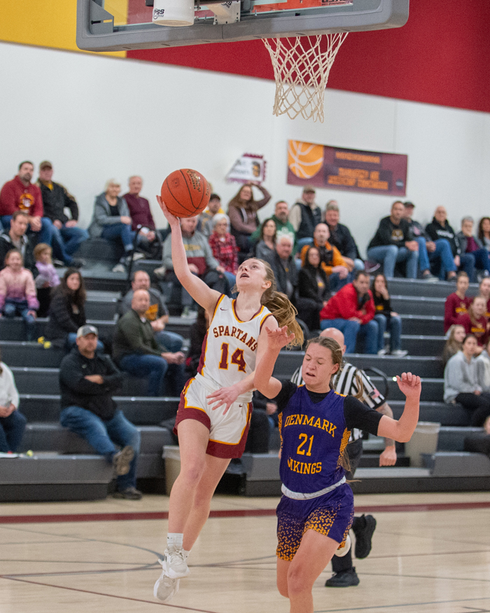 Nora Krause was all over the court for Algoma on Monday. Here, she scores on a drive to the basket with a defender keeping stride. Josh Staloch photo