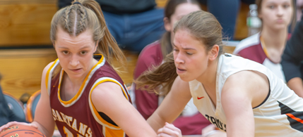 With head coach Beth Budnik watching intently from the sidelines, L-C’s Sienna Blohowiak gets around her defender along the baseline and heads for the basket