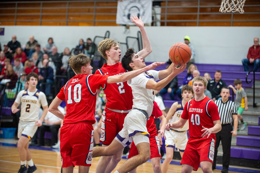 Kewaunee's Thomas Stangel splits a pair of defenders on his way to the basket Tuesday at home against Sturgeon Bay
