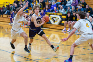 Kewaunee's Avery Jerabek, with Algoma's Jack Tebon alongside him and Braeden Leist waiting, looks to make a pass