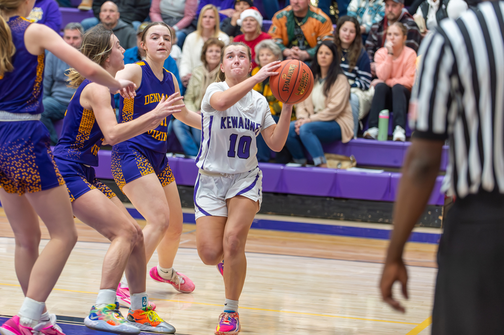 Kewaunee's Summer Walechka goes baseline on a trio of Denmark defenders as the Storm captured their 10th victory of the season on Friday, Dec. 29