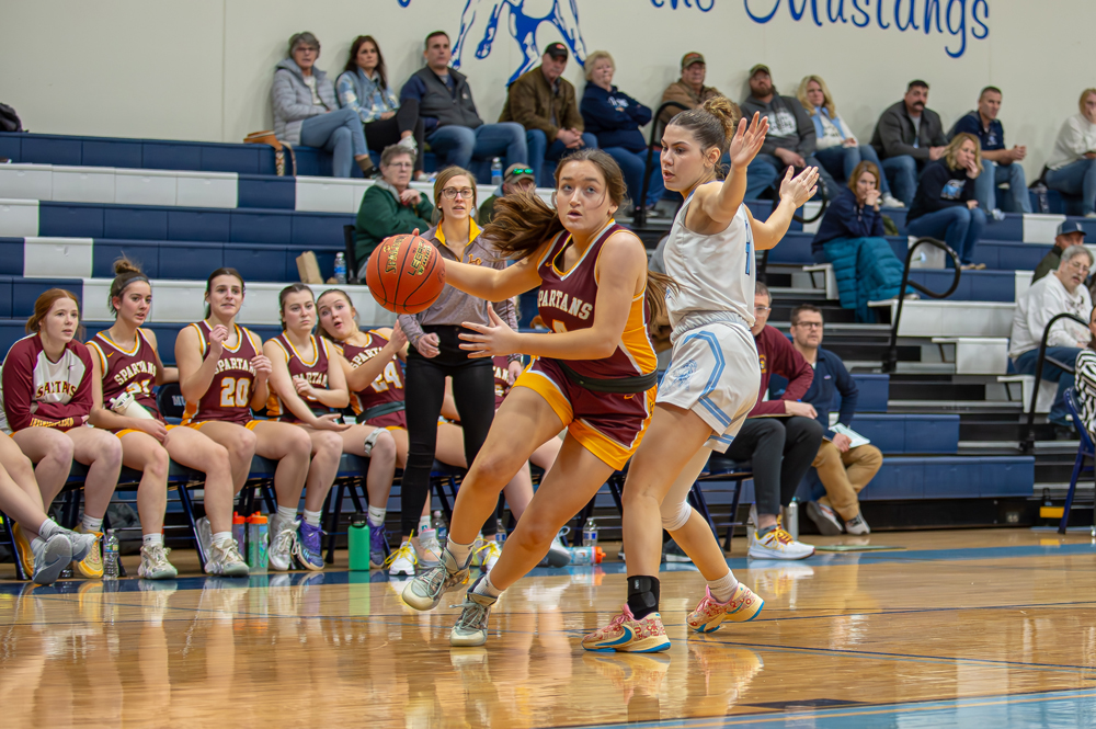 With coach Beth Budnik and the rest of the L-C team watching intently from the sideline, Taylor Jandrin gets a step on her defender and heads for the basket