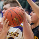 Kewaunee’s Braxton Riha, middle, does his best to maintain possession of the ball against a swarm of Algoma defenders as the Storm and the Wolves squared off in the regular season finale on Friday, Feb. 22