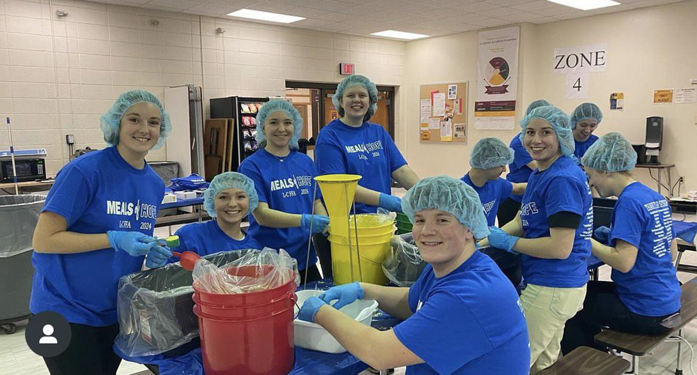 Volunteers put the dry ingredients provided by Meals of Hope into bags to be sealed. Pictured from left are Katie Ledvina, Morgan DeJardin, Marissa Annoye, Gabi Engebose, Caleb Salentine and Cadi Bevins